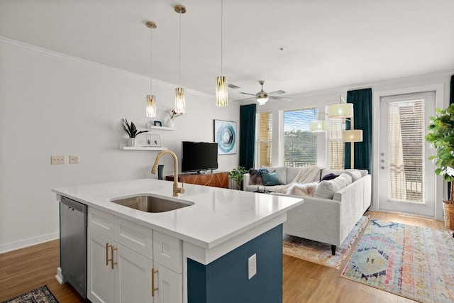 kitchen with sink, white cabinetry, a center island with sink, light wood-type flooring, and dishwasher