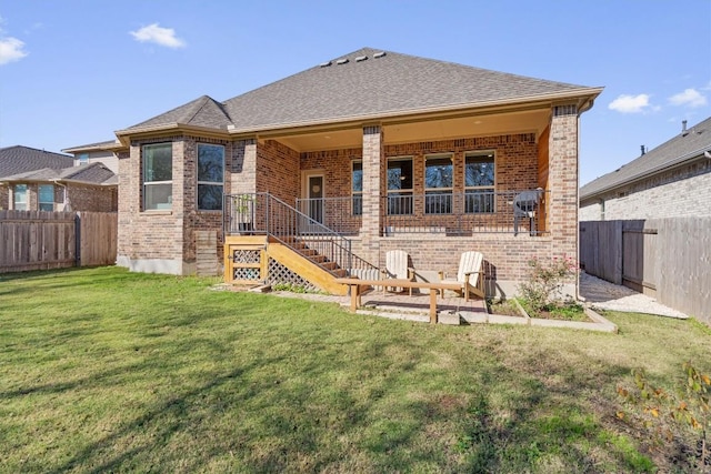 rear view of house with a lawn