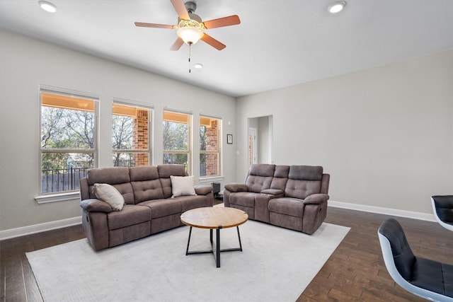 living room with dark hardwood / wood-style floors and ceiling fan