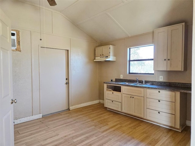 kitchen with vaulted ceiling, sink, ceiling fan, and light hardwood / wood-style floors