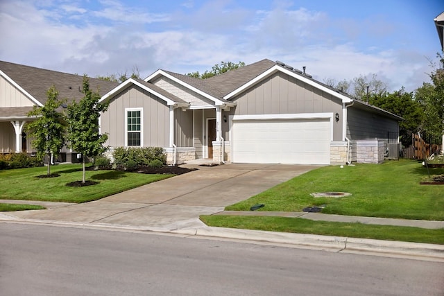 craftsman inspired home featuring a garage and a front lawn