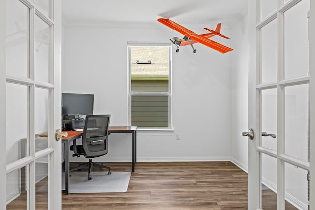 office area with hardwood / wood-style flooring and ornamental molding