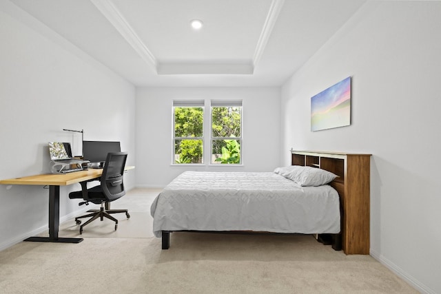 carpeted bedroom with crown molding and a tray ceiling