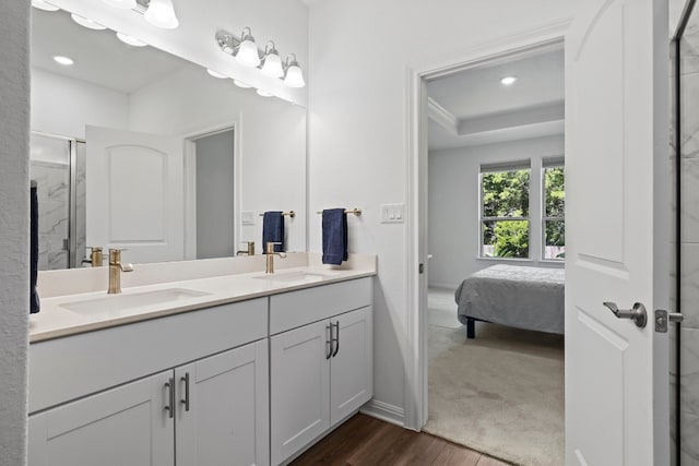 bathroom featuring vanity, a tray ceiling, wood-type flooring, and walk in shower