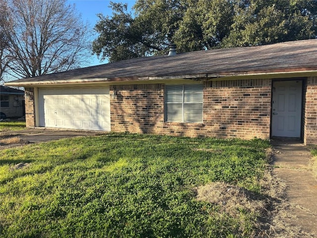 ranch-style house with a garage and a front yard