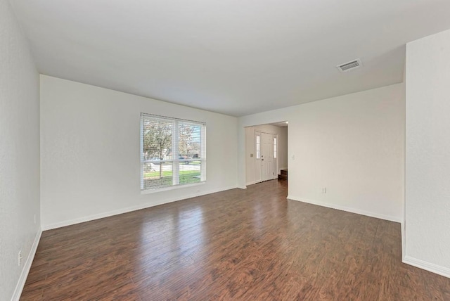 spare room featuring dark hardwood / wood-style flooring