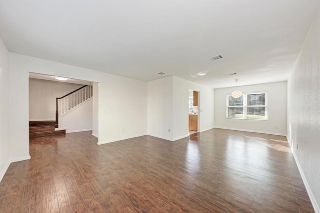 unfurnished room with dark wood-type flooring