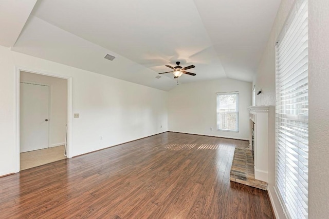 unfurnished living room with vaulted ceiling, dark hardwood / wood-style floors, and ceiling fan