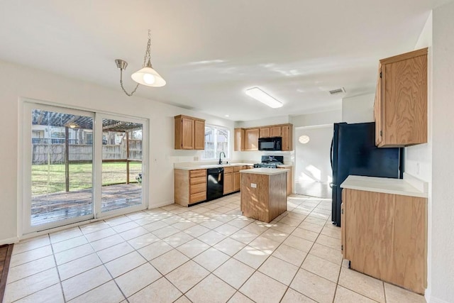 kitchen featuring a kitchen island, decorative light fixtures, sink, light tile patterned floors, and black appliances