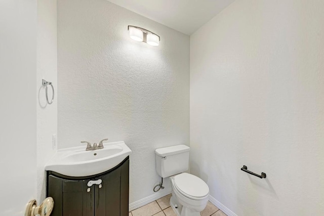 bathroom with vanity, tile patterned floors, and toilet