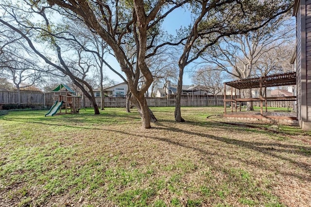 view of yard with a pergola and a playground