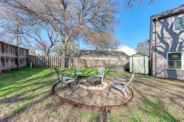 view of yard featuring a storage shed and a fire pit