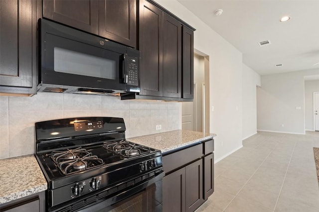 kitchen featuring light stone countertops, dark brown cabinets, and black appliances