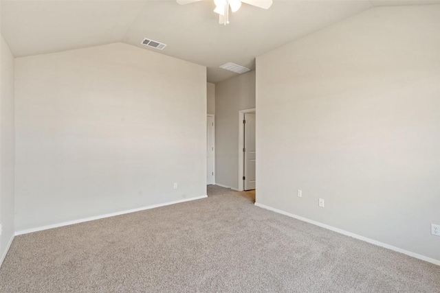 empty room with ceiling fan, carpet floors, and vaulted ceiling