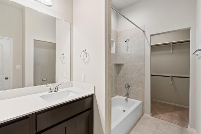 bathroom featuring vanity, tile patterned floors, and tiled shower / bath