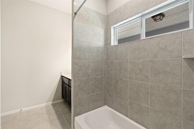 bathroom with tiled shower / bath combo, vanity, and tile patterned floors