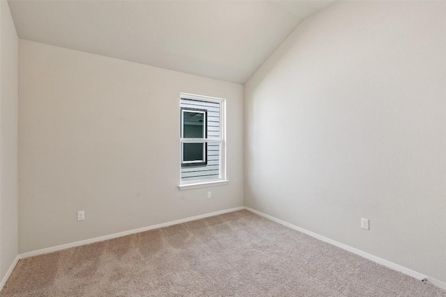 spare room with lofted ceiling and carpet floors