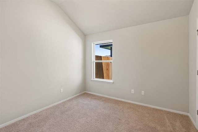 spare room with lofted ceiling and carpet