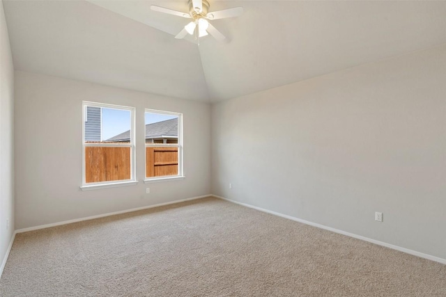 spare room with ceiling fan, lofted ceiling, and carpet floors