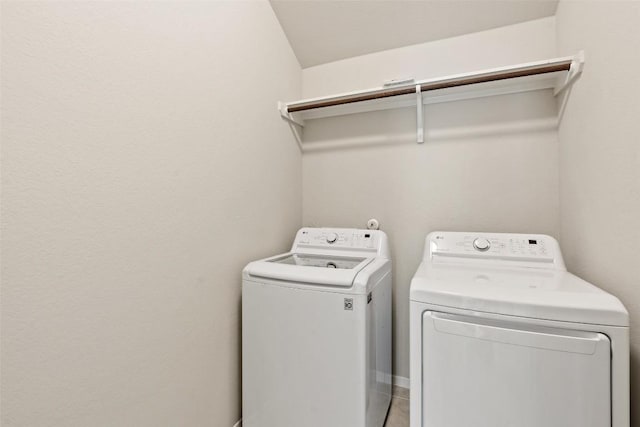 clothes washing area with washing machine and clothes dryer