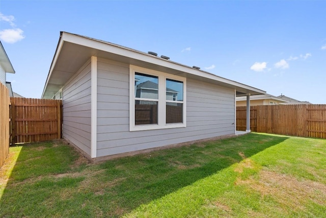 view of home's exterior with a yard