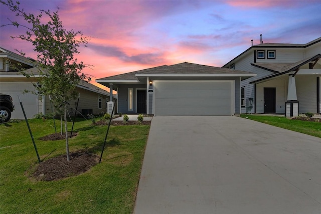 view of front facade featuring a garage and a lawn