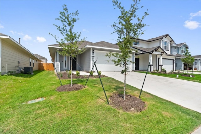 view of front of house with cooling unit, a garage, and a front lawn