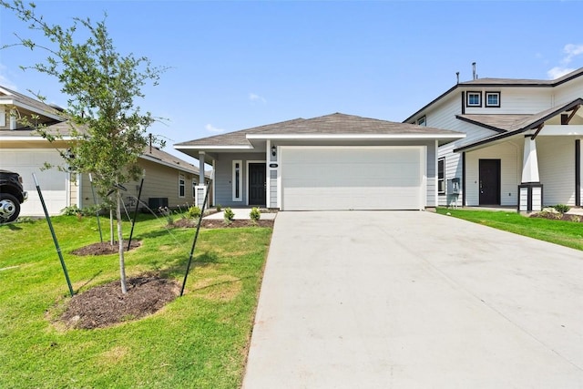 view of front of house featuring a garage, a front yard, and covered porch