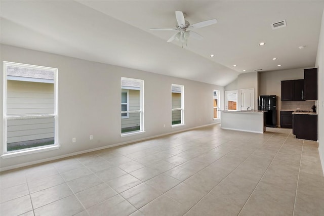 unfurnished living room with light tile patterned flooring, ceiling fan, plenty of natural light, and lofted ceiling