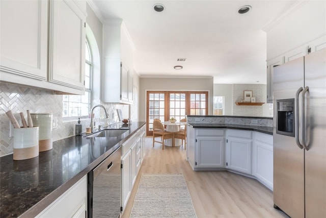 kitchen featuring stainless steel appliances, white cabinetry, sink, and ornamental molding