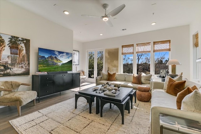 living room featuring ceiling fan and light hardwood / wood-style floors