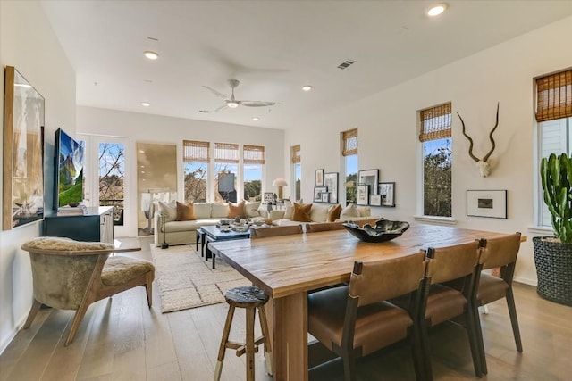 dining space featuring ceiling fan and light wood-type flooring