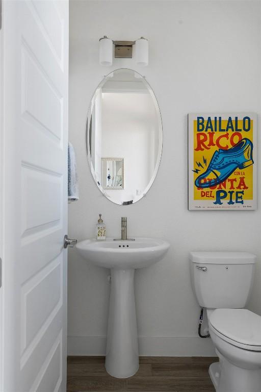 bathroom featuring hardwood / wood-style flooring and toilet