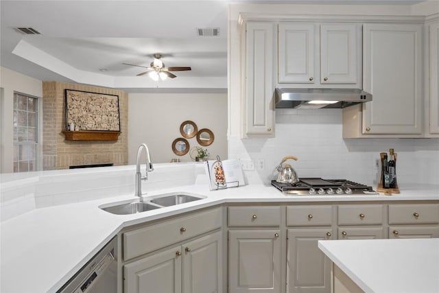 kitchen featuring sink, dishwashing machine, ceiling fan, stainless steel gas stovetop, and backsplash