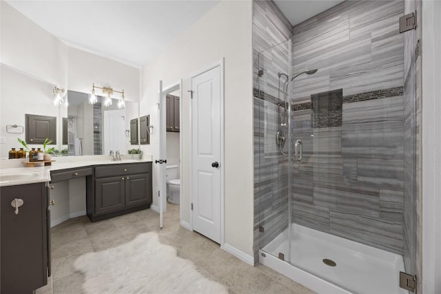 bathroom with vanity, tile patterned flooring, a shower with door, and toilet