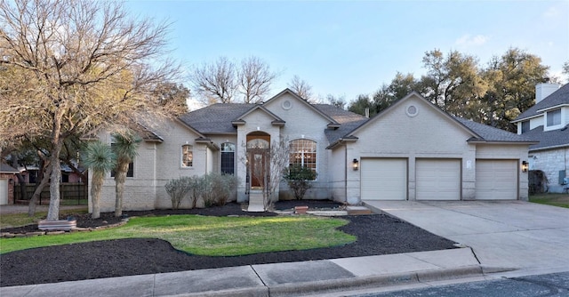 view of front of property featuring a garage and a front yard