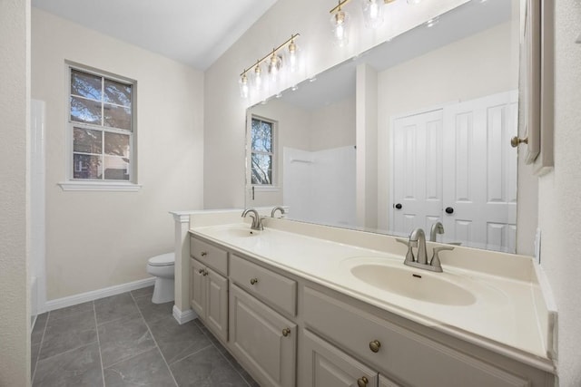 bathroom featuring vanity, tile patterned floors, and toilet