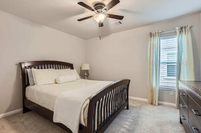 bedroom featuring light carpet, multiple windows, visible vents, and baseboards