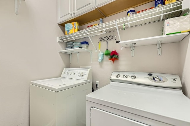 laundry room featuring cabinet space and separate washer and dryer