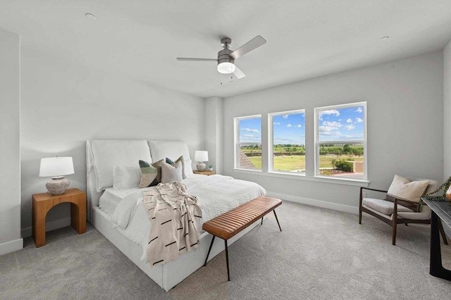 bedroom with light colored carpet and ceiling fan