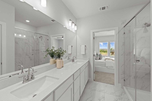 bathroom featuring vanity and a shower with door