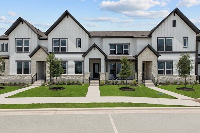 modern inspired farmhouse with a front lawn