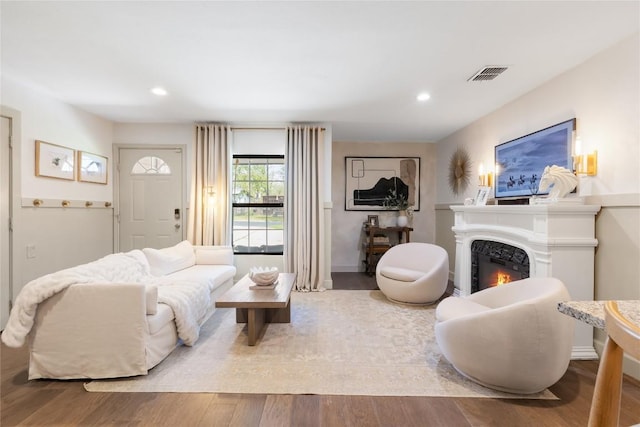 5410 Overbrook Dr, Austin, TX 78723 - living room featuring a warm lit fireplace, recessed lighting, and wood finished floors