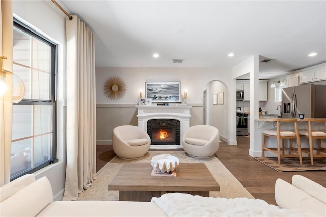 5410 Overbrook Dr, Austin, TX 78723 - living room featuring recessed lighting, light wood finished floors, a warm lit fireplace, and plenty of natural light