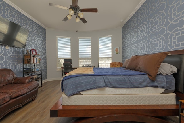 bedroom with light hardwood / wood-style flooring, ornamental molding, and ceiling fan