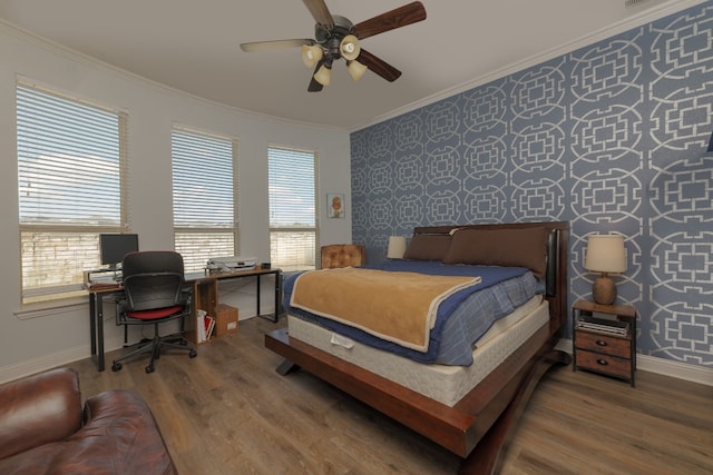 bedroom with crown molding, hardwood / wood-style floors, and ceiling fan