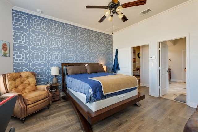 bedroom with hardwood / wood-style flooring, ceiling fan, and ornamental molding