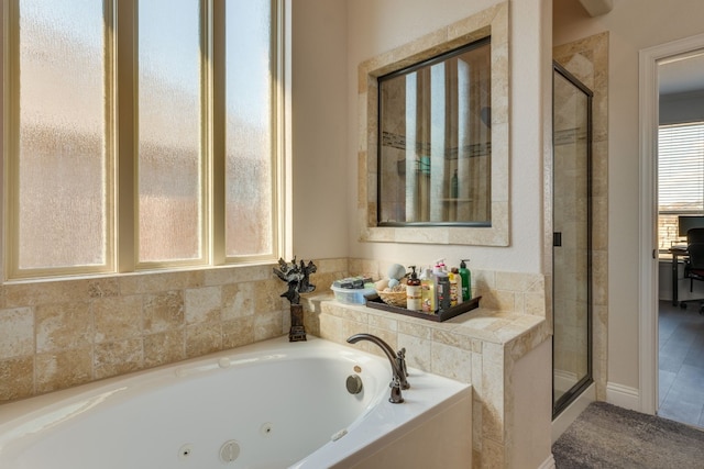 bathroom featuring shower with separate bathtub