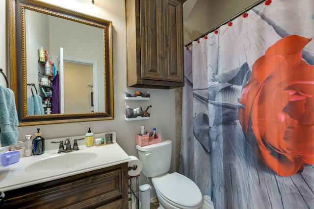 bathroom with vanity, toilet, and walk in shower