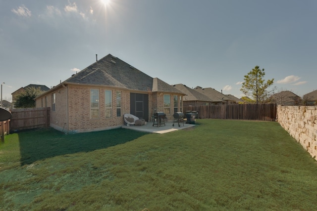 back of property featuring a lawn and a patio